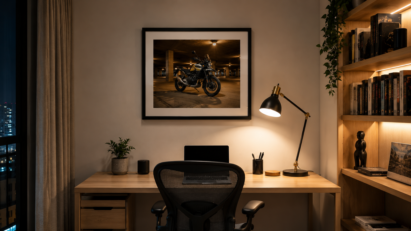 Motorcycle framed print hung above home study desk at night